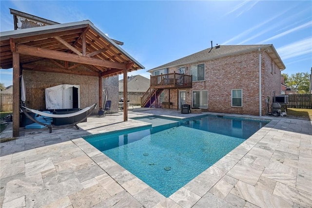 view of swimming pool with a patio area, a deck, and a gazebo