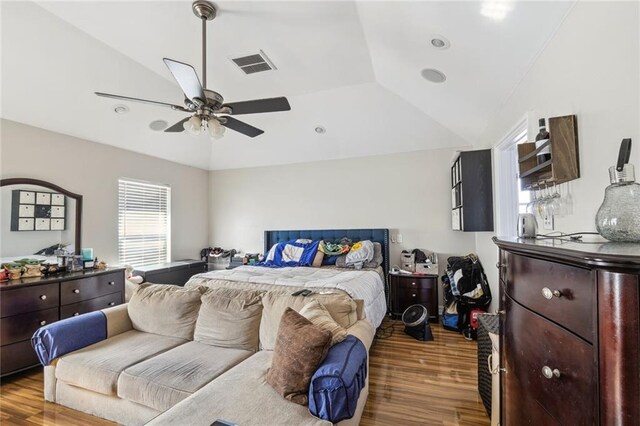 bedroom featuring hardwood / wood-style floors, lofted ceiling, and ceiling fan