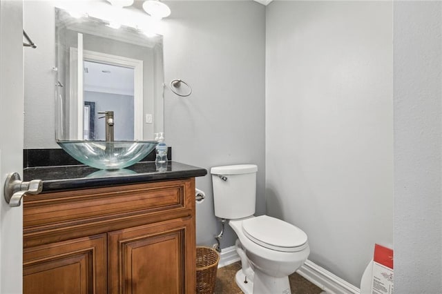 bathroom with vanity with extensive cabinet space, toilet, and tile floors