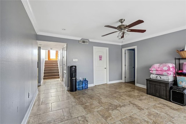 interior space with ornamental molding, ceiling fan, and light tile floors