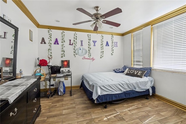 bedroom featuring ornamental molding, wood-type flooring, and ceiling fan