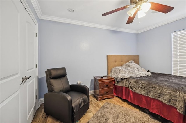 bedroom with ornamental molding, ceiling fan, and hardwood / wood-style floors