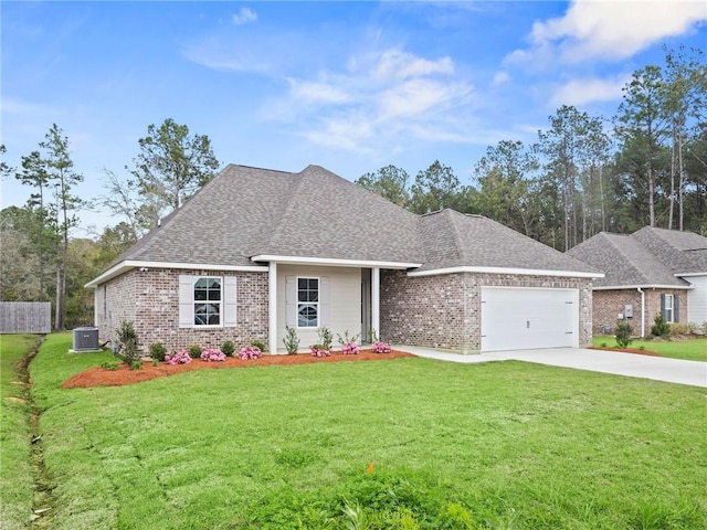 view of front of house with central AC, a front yard, and a garage