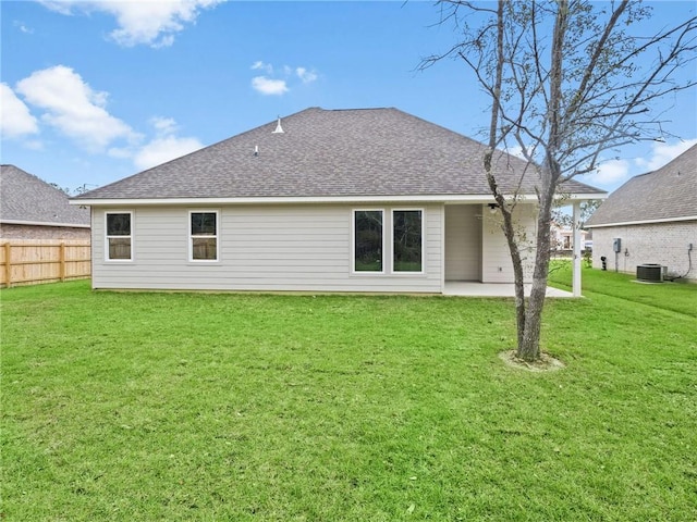 rear view of house with a lawn, a patio, and central air condition unit