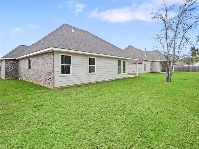 rear view of property featuring a yard