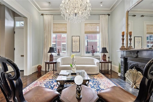 interior space featuring crown molding, an inviting chandelier, dark hardwood / wood-style flooring, and a tile fireplace