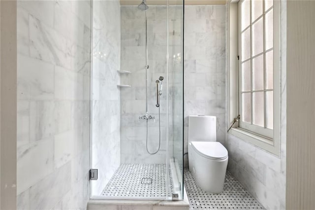 bathroom featuring tile walls, walk in shower, toilet, and a healthy amount of sunlight