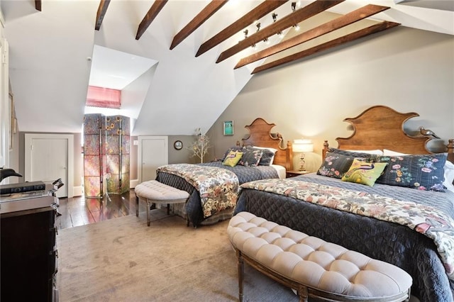 bedroom with wood-type flooring and lofted ceiling with beams