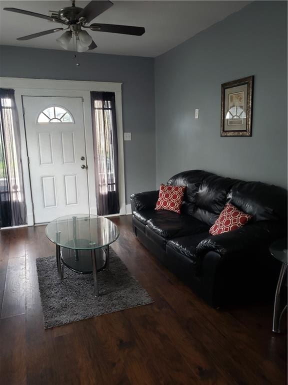 living room featuring dark hardwood / wood-style flooring and ceiling fan