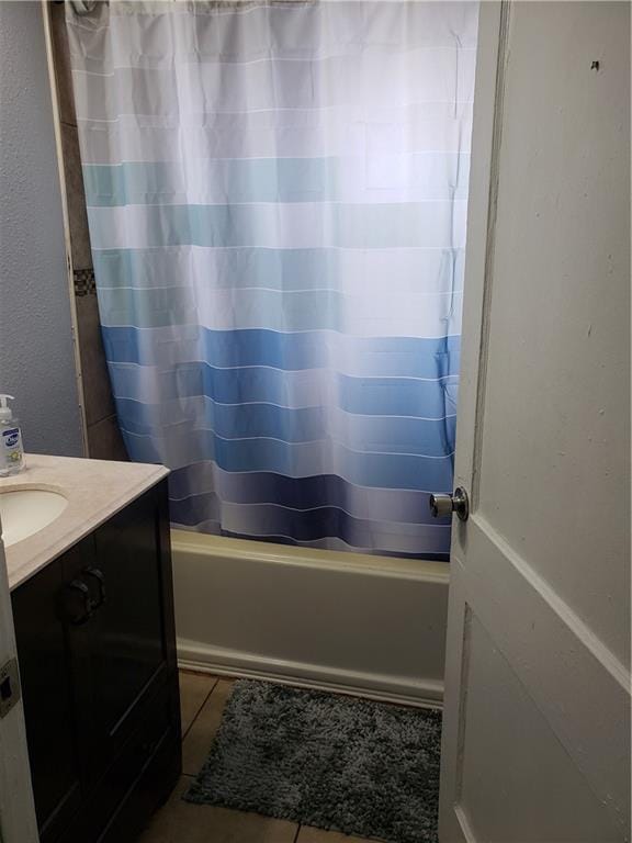 bathroom featuring tile flooring, vanity, and shower / tub combo with curtain