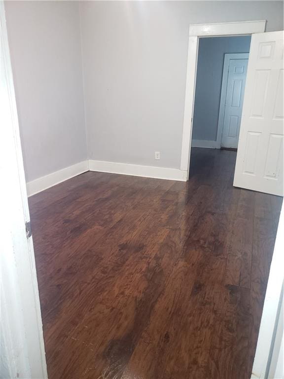 spare room featuring dark hardwood / wood-style flooring