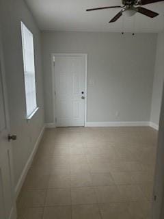 tiled empty room with ceiling fan