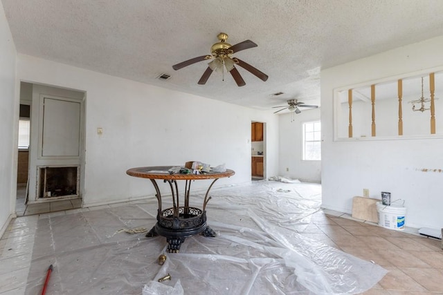 interior space featuring ceiling fan and a textured ceiling