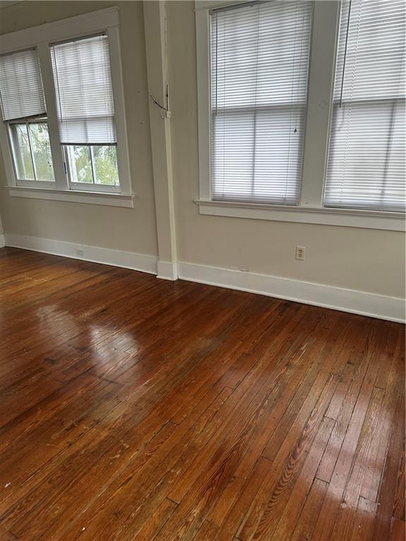 empty room featuring hardwood / wood-style flooring and plenty of natural light