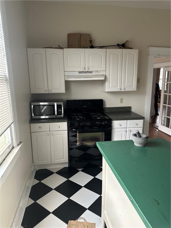 kitchen featuring white cabinets and black range with gas stovetop