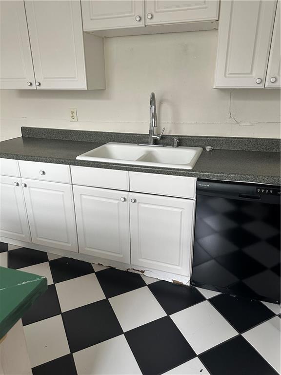 kitchen featuring white cabinetry, dishwasher, and sink