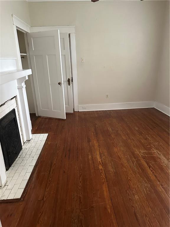 unfurnished living room featuring a fireplace and hardwood / wood-style floors