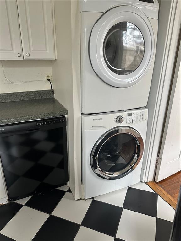 clothes washing area featuring stacked washer / dryer