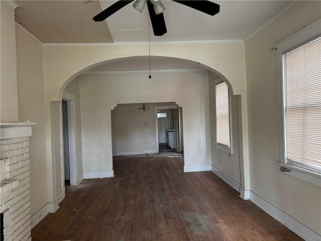 empty room with ceiling fan, dark hardwood / wood-style flooring, and crown molding