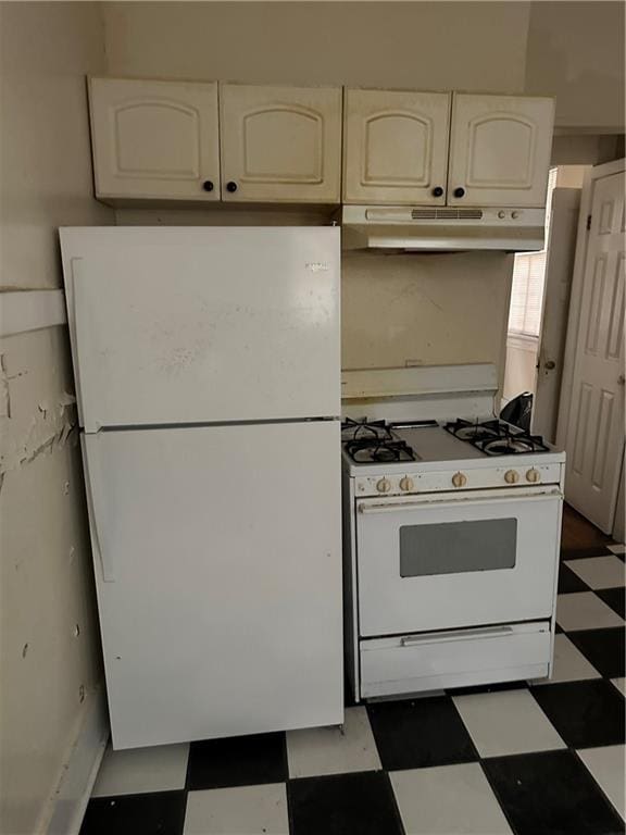 kitchen featuring white appliances and white cabinets