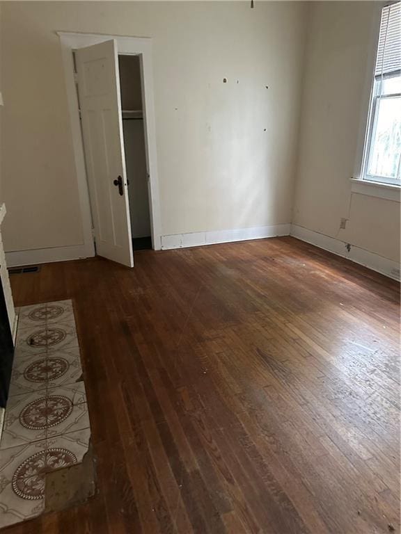 empty room with dark wood-type flooring