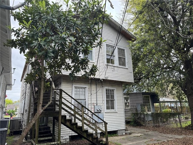 rear view of house with central air condition unit