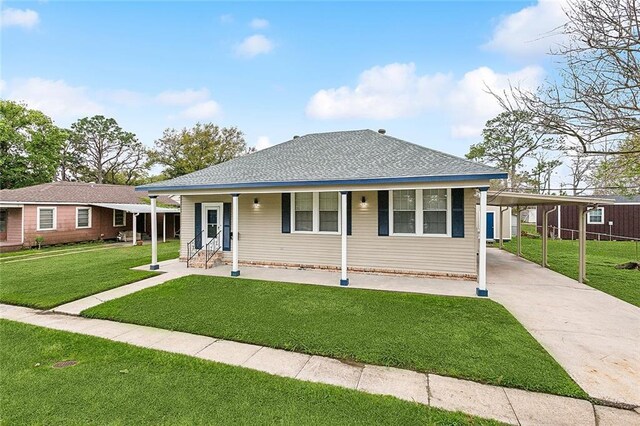 view of front of property with a front yard and a carport