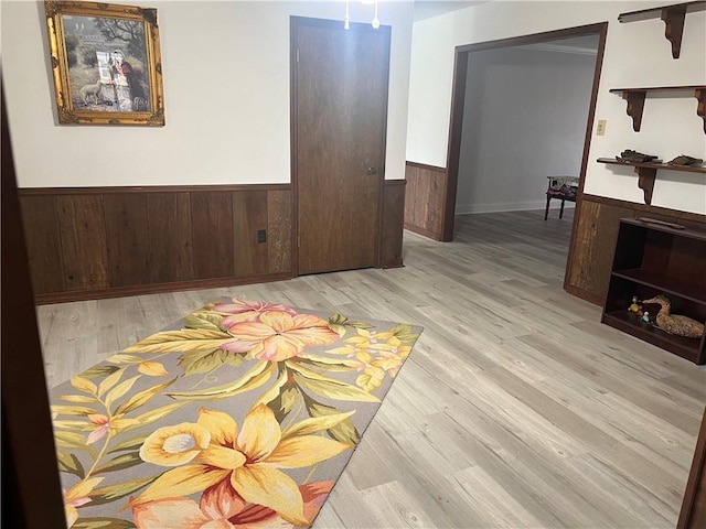 empty room featuring light hardwood / wood-style floors and wood walls