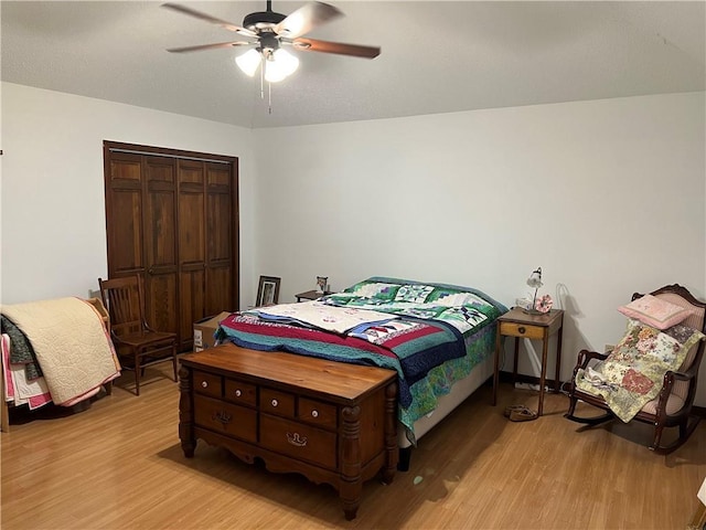 bedroom featuring light hardwood / wood-style flooring, a closet, and ceiling fan