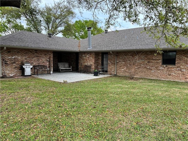 back of house with a patio area and a lawn