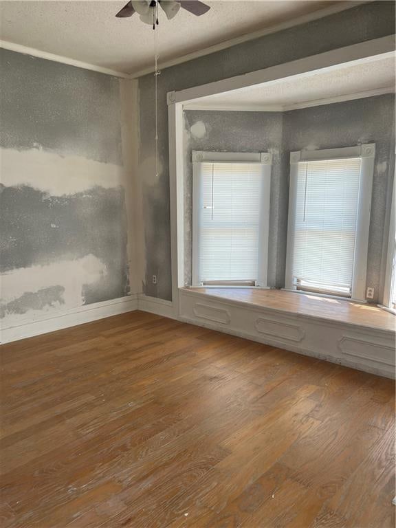 unfurnished room featuring ceiling fan and hardwood / wood-style flooring