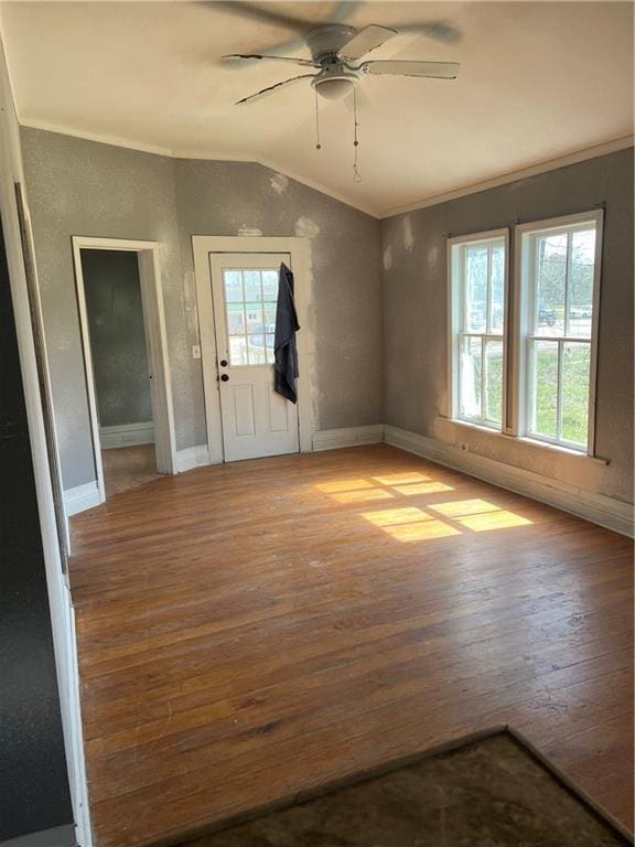 unfurnished room featuring hardwood / wood-style flooring, crown molding, ceiling fan, and lofted ceiling