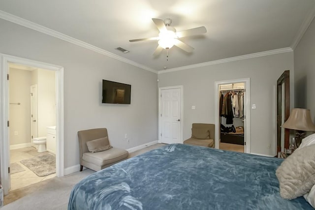 bedroom featuring ceiling fan, ornamental molding, ensuite bath, and a closet