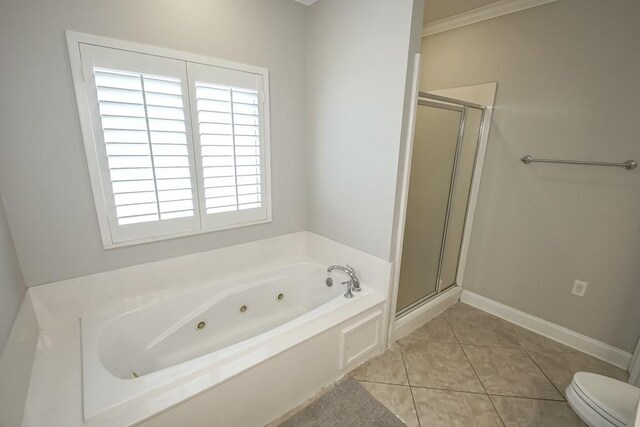 bathroom featuring separate shower and tub, toilet, tile floors, and a wealth of natural light