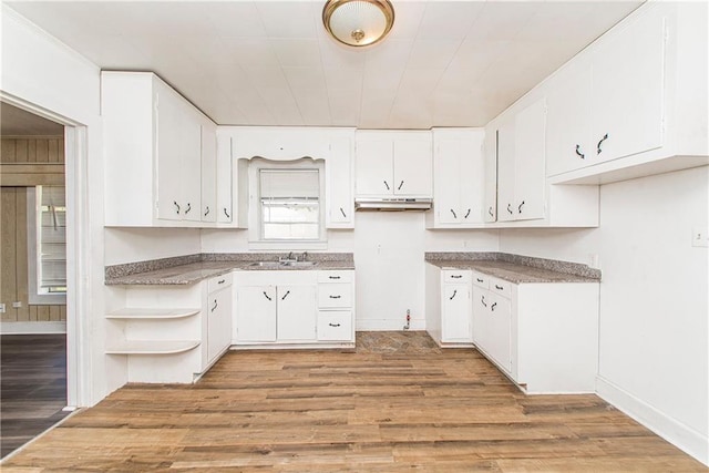 kitchen with sink, white cabinets, and light wood-type flooring