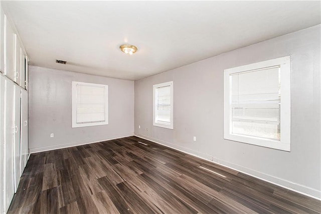 unfurnished room with dark hardwood / wood-style floors