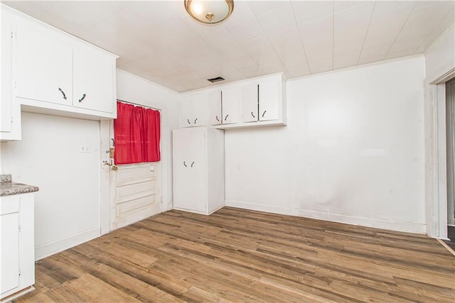 kitchen with white cabinets and wood-type flooring