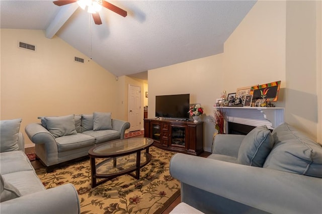 living room featuring ceiling fan and lofted ceiling with beams