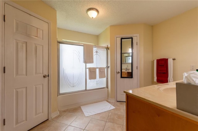 bathroom featuring tile flooring, bathtub / shower combination, vanity, and a textured ceiling