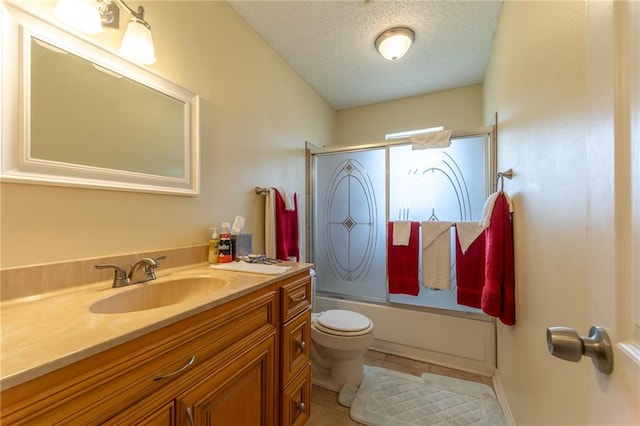 full bathroom featuring toilet, oversized vanity, a textured ceiling, enclosed tub / shower combo, and tile flooring