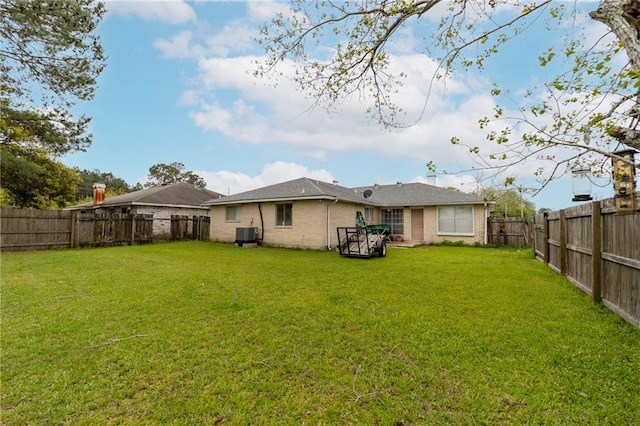 rear view of property featuring a lawn