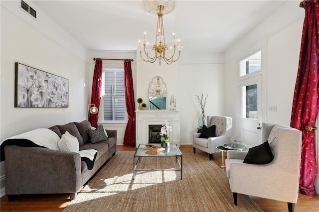 living room with a chandelier and hardwood / wood-style floors