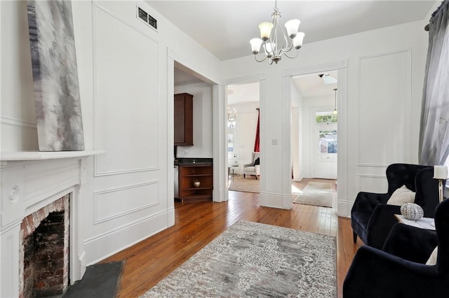 living area featuring a chandelier and dark hardwood / wood-style flooring