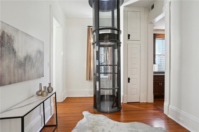 interior space with dark hardwood / wood-style flooring and an inviting chandelier