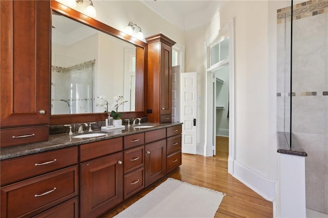 bathroom with hardwood / wood-style floors and dual vanity