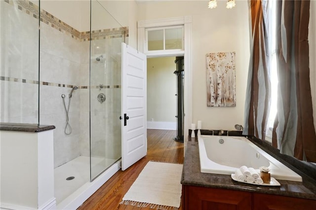 bathroom featuring shower with separate bathtub and hardwood / wood-style floors