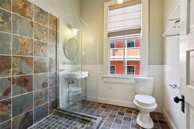 bathroom with tile flooring, toilet, and sink