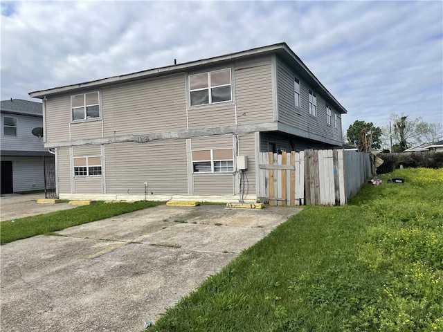 rear view of house with a yard