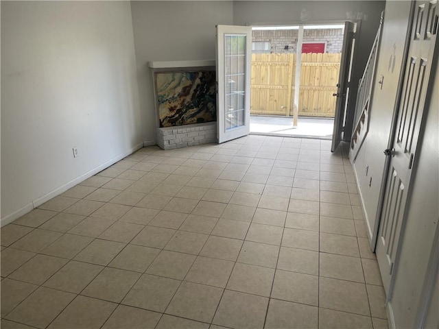 unfurnished living room with light tile flooring