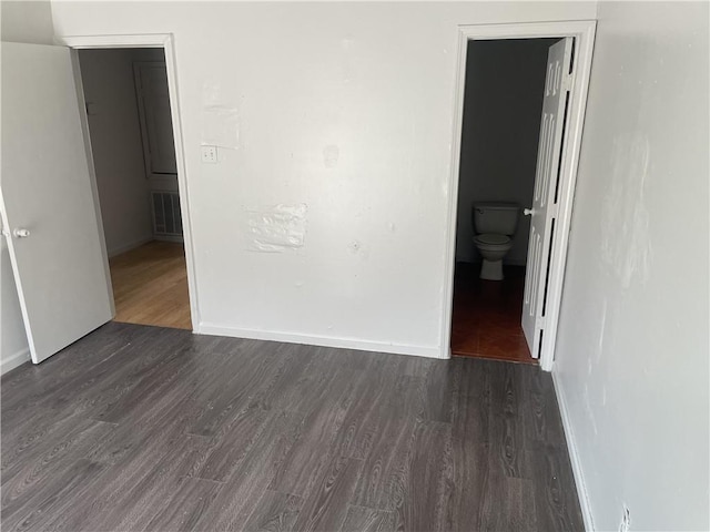 empty room featuring dark wood-type flooring